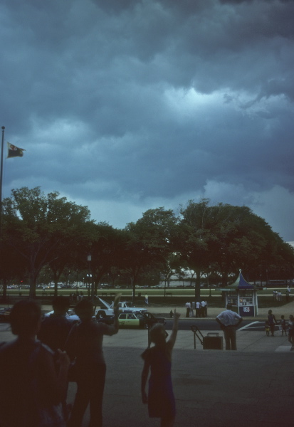 Bystanders point to the sky in front of the Air and Space Musem