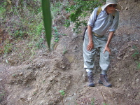 David negotiates the short, tricky section of washed out trail.