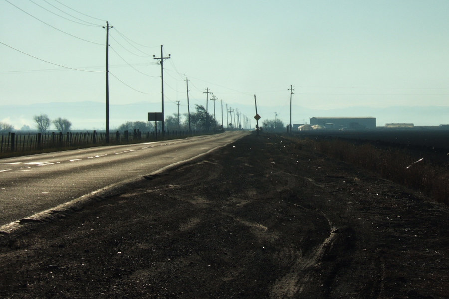 Light traffic and no shoulder describes Frazier Lake Road as it extends to the horizon.