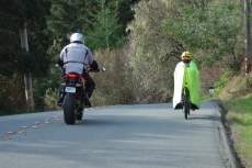 A motorcyclist passes.